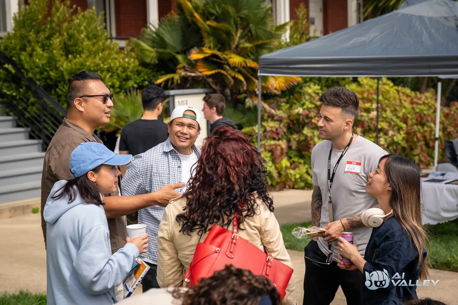 Attendees sharing a conversation outdoors at Dogathon - AI Valley community event